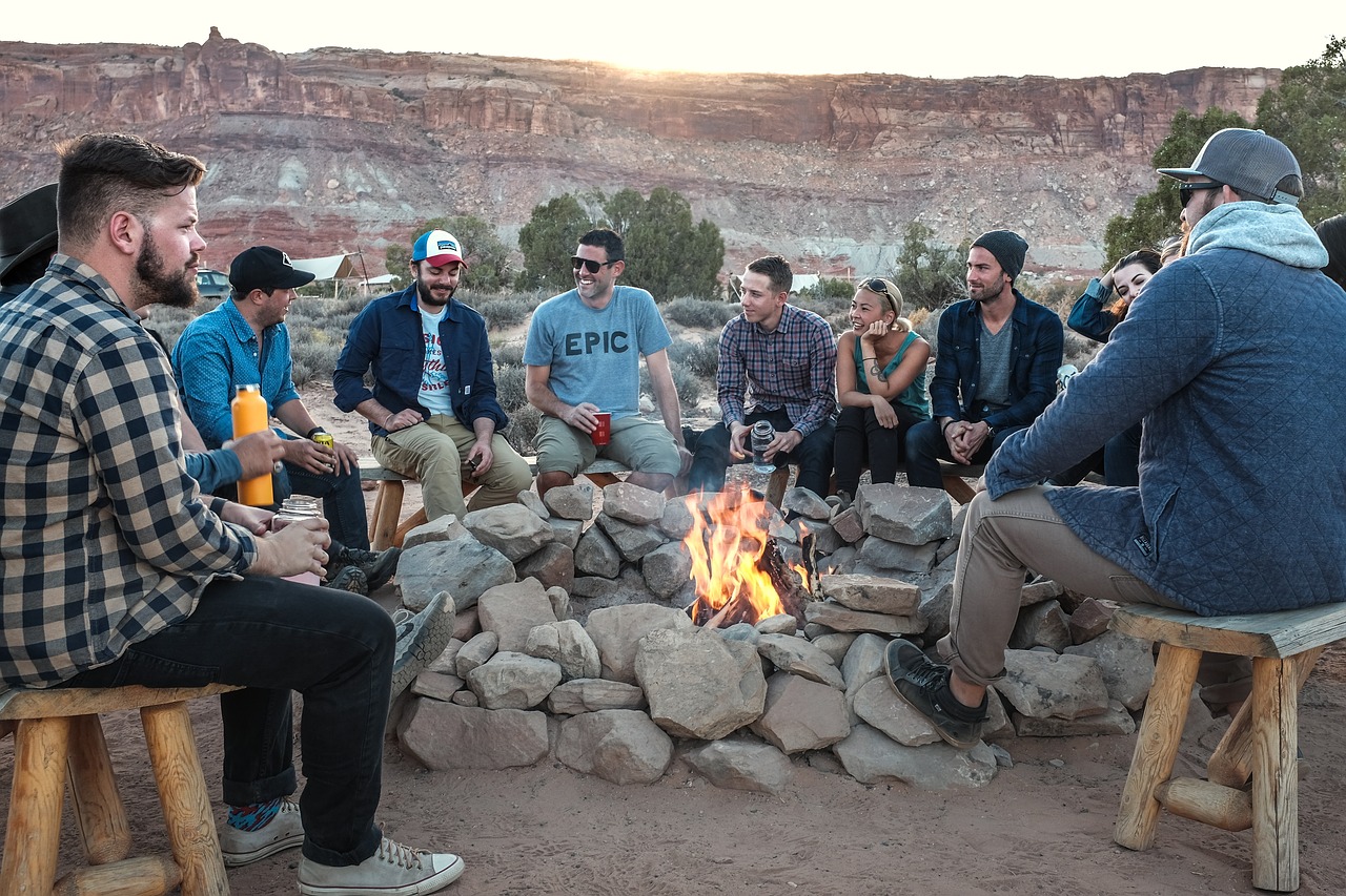 Men around a campfire. The best camping gear ensures a fun foray into nature.