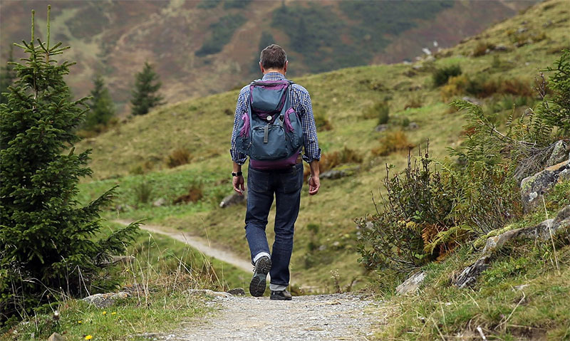 man hiking with lightweight backpack